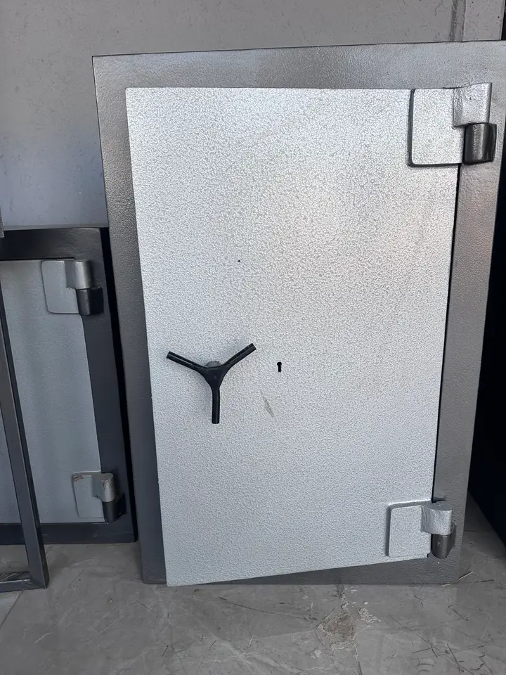 Tall Shellmate high-security safe door with three-spoke handle and heavy hinges